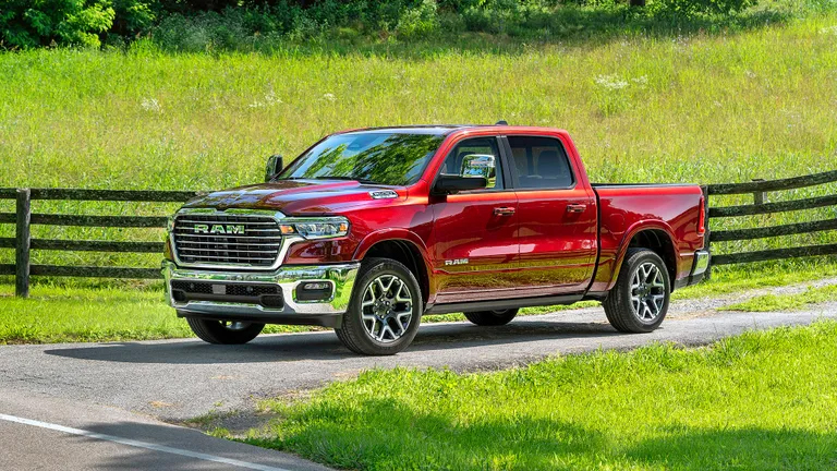 Our 2025 Ram 1500 Laramie 4x4 long-termer in Delmonico Red on a country road.